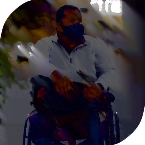 A young Hispanic man wearing a mask and using a wheelchair. He is a double amputee.